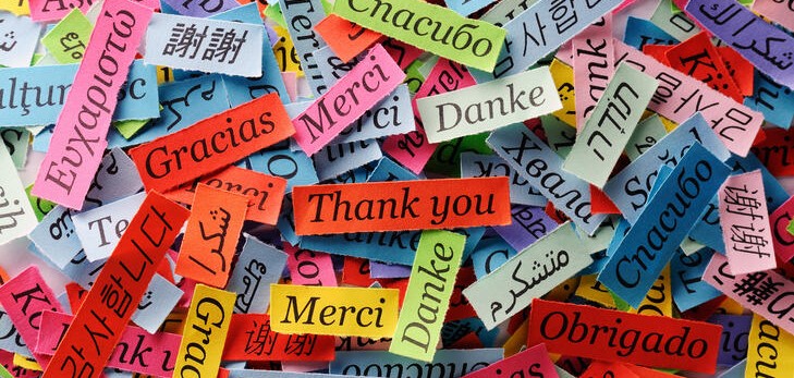 a pile of colourful paper with words in different languages