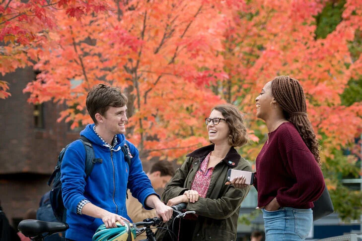 Students socialising outside in autumn