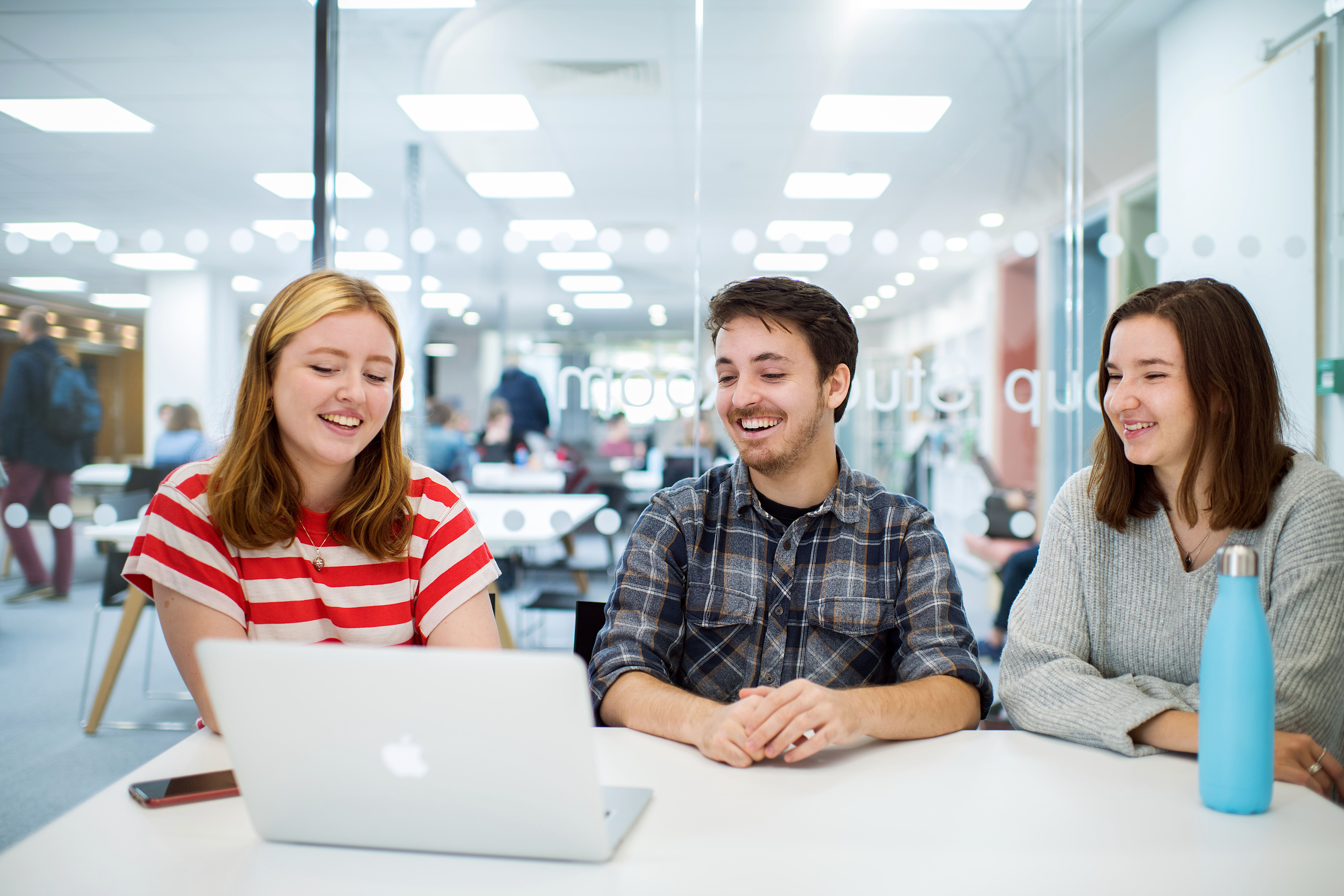 group of three students studying together