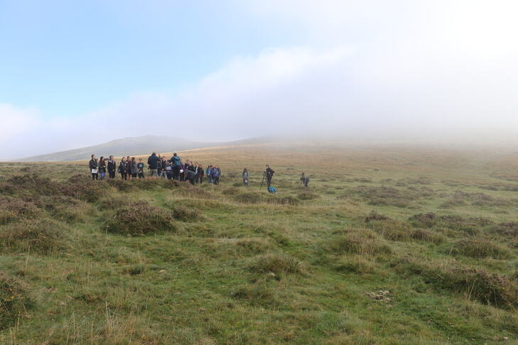 Students and staff on fieldtrip stood on grassy moor