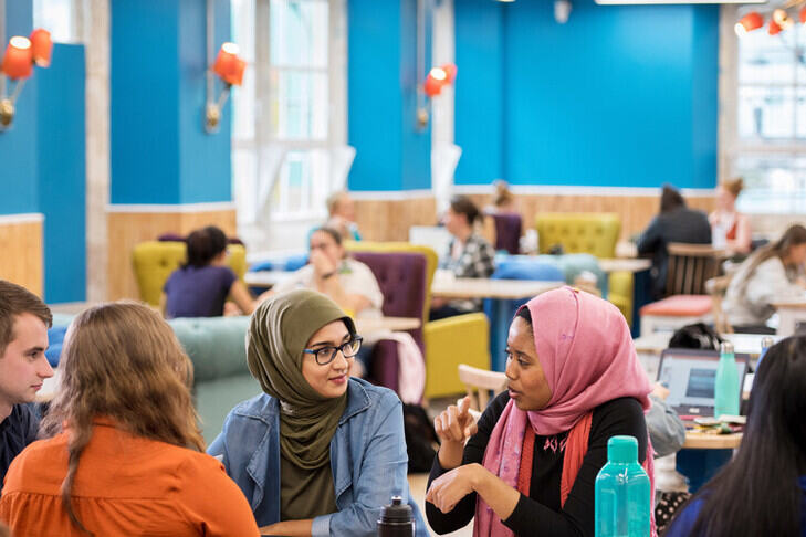 Students talking around a table