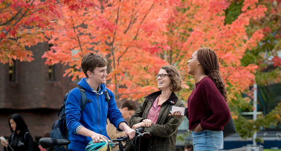 Students socialising outside in autumn