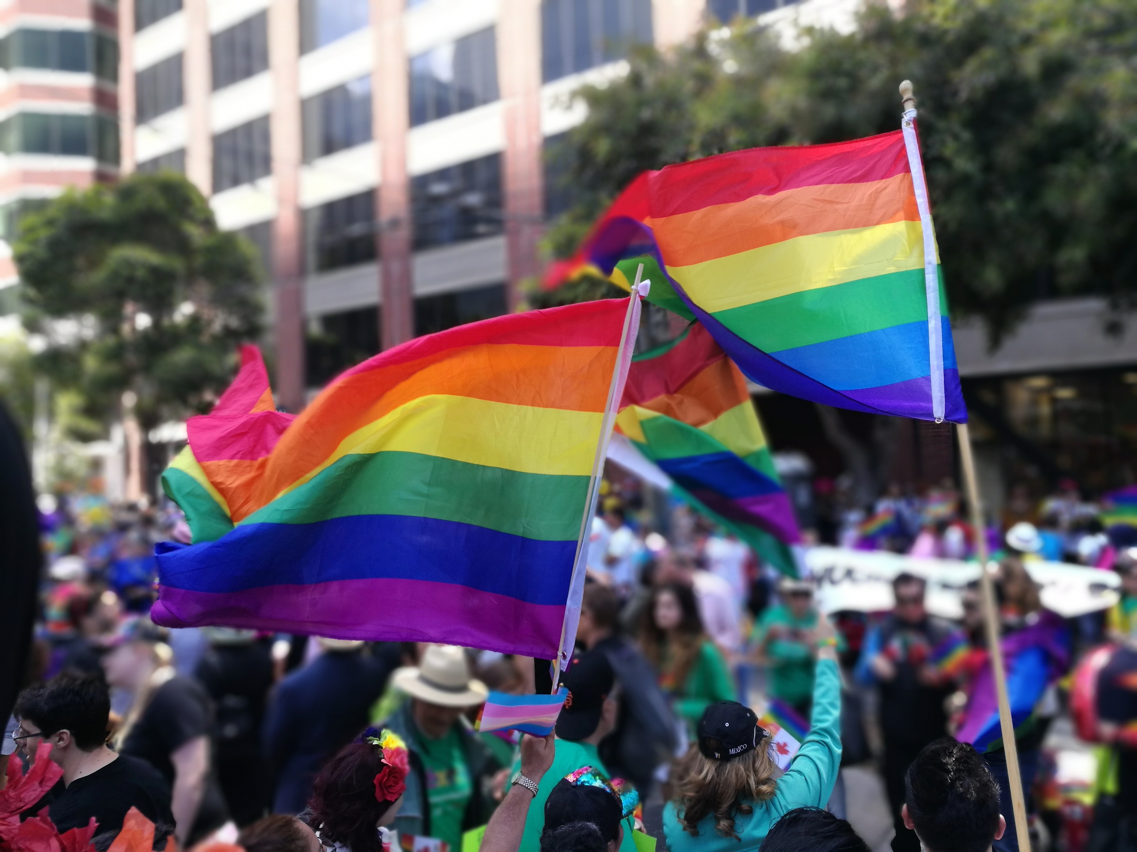 Rainbow pride flags with small trans pride flag at pride parade