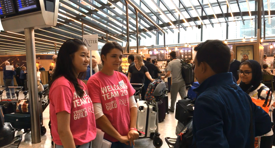 students welcoming new arrivals at the airport