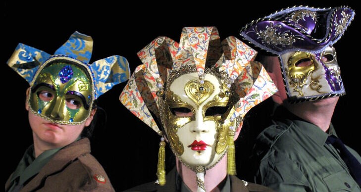 students wearing traditional drama masks
