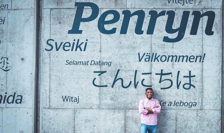 student standing in front of a wall reading Penryn